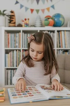 IMAGEN: una nena de 5 años jugando a encontrar objetos que empiezan con M, con su mamá